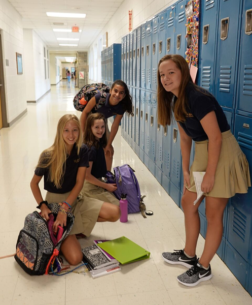 St. Mark School middle-schoolers in Huntersville show off their new backpacks and school supplies on their first day back to class Aug. 22. (Photo courtesy of Amy Burger )