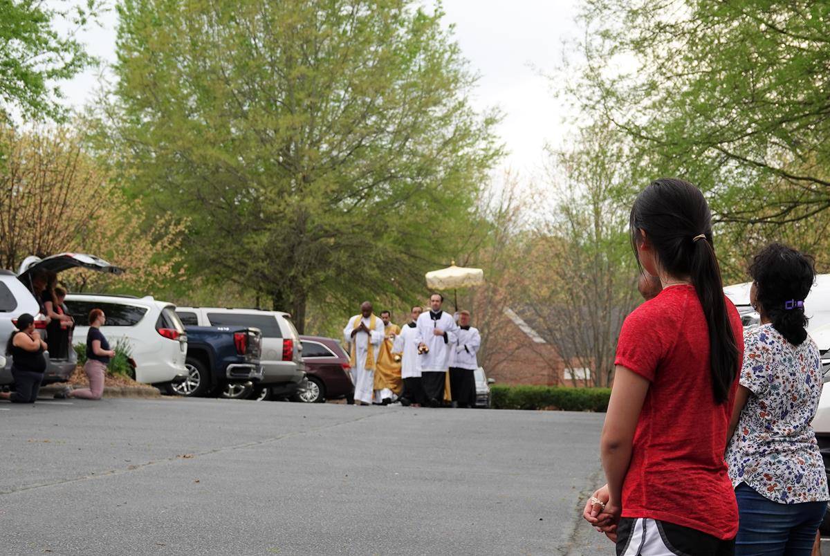 Father John Putnam, pastor, leads a Eucharistic procession outside St. Mark Church in Huntersville during Holy Week. (Photo provided by Amy Burger)