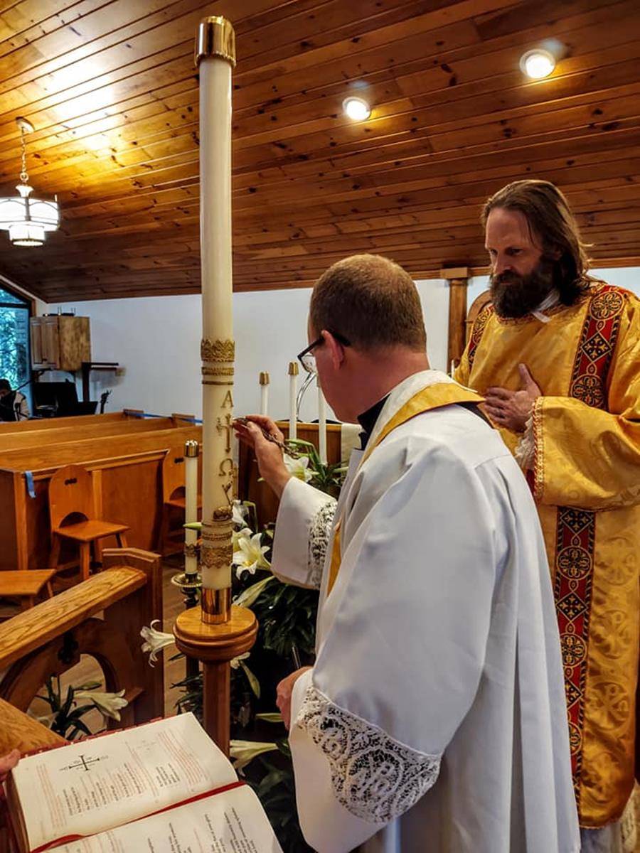 Father Casey Coleman, pastor, and Deacon Matthew Newsome celebrate the Easter Vigil at St. Mary Mother of God Church in Sylva. (Photo via Facebook)