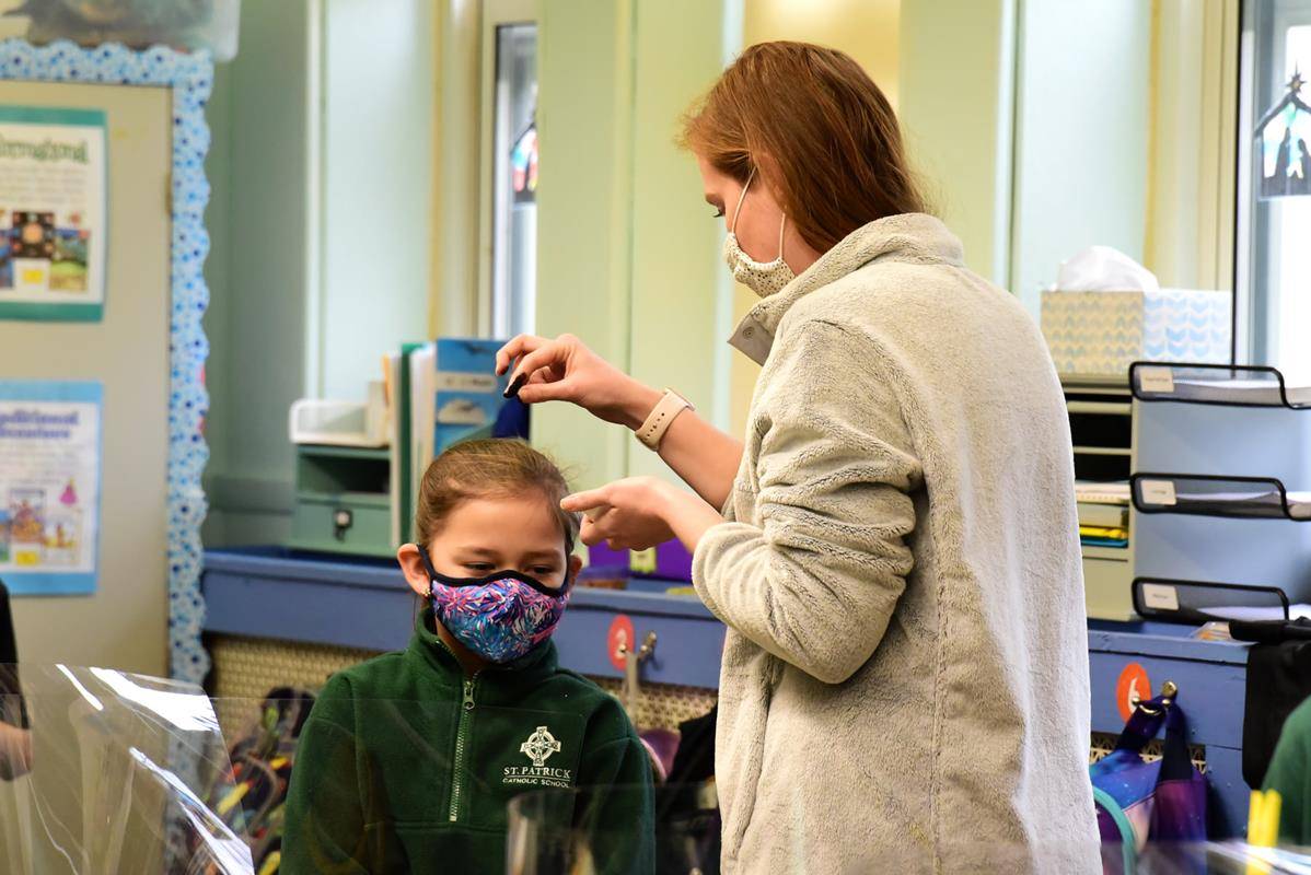 CHARLOTTE — Father Christopher Roux led an Ash Wednesday Liturgy of the Word over St. Patrick's School for students. Near the end of the liturgy, the teachers sprinkled ashes upon the heads of their students in each of the classrooms. (Photo via Facebook)