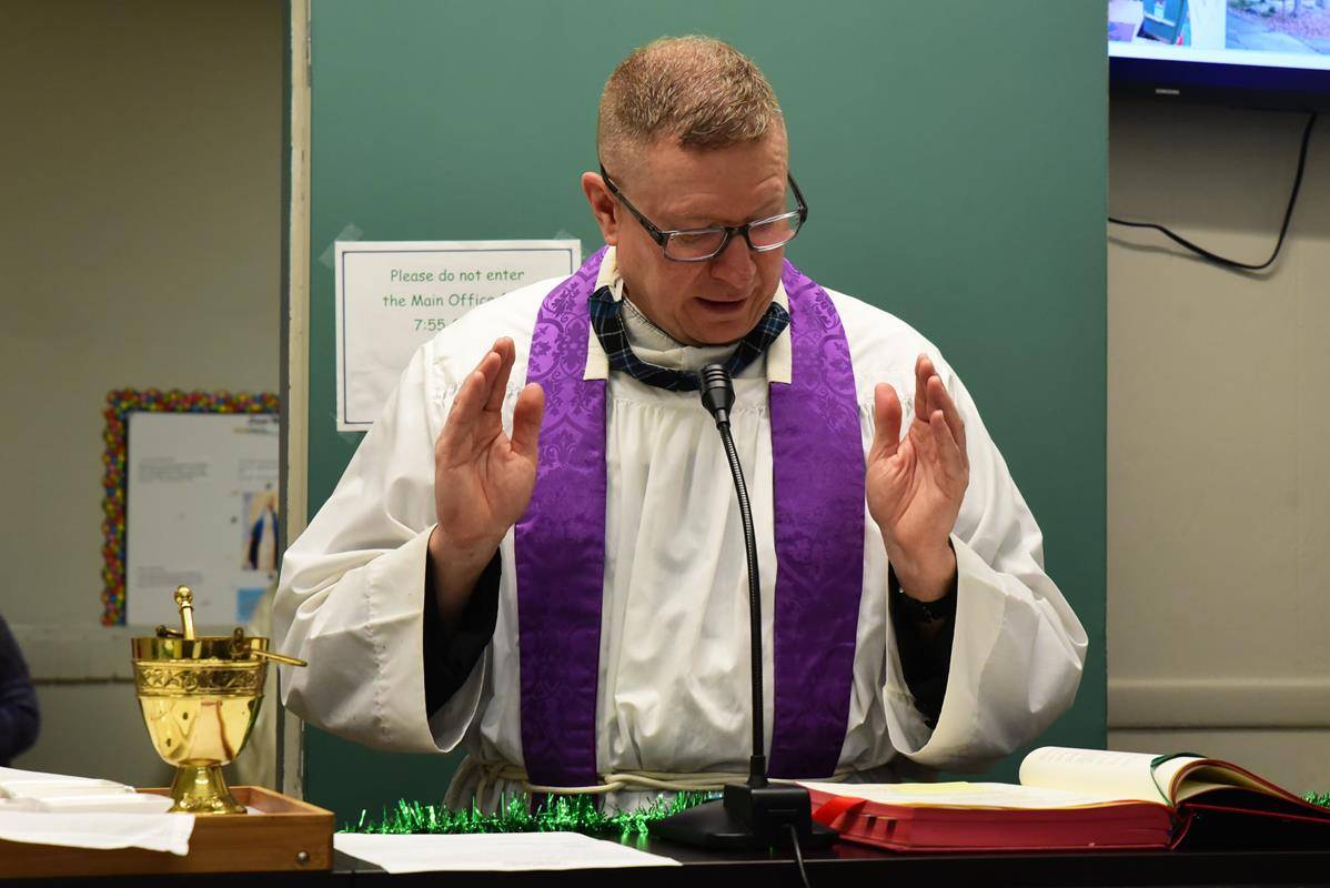 CHARLOTTE — Father Christopher Roux led an Ash Wednesday Liturgy of the Word over St. Patrick's School for students. Near the end of the liturgy, the teachers sprinkled ashes upon the heads of their students in each of the classrooms. (Photo via Facebook)