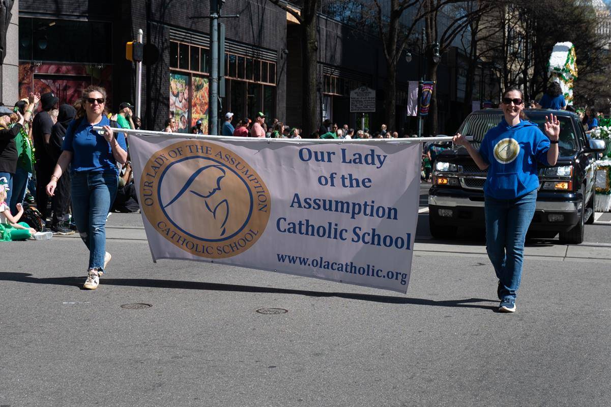 Students, staff and family of Our Lady of the Assumption march in the parade.