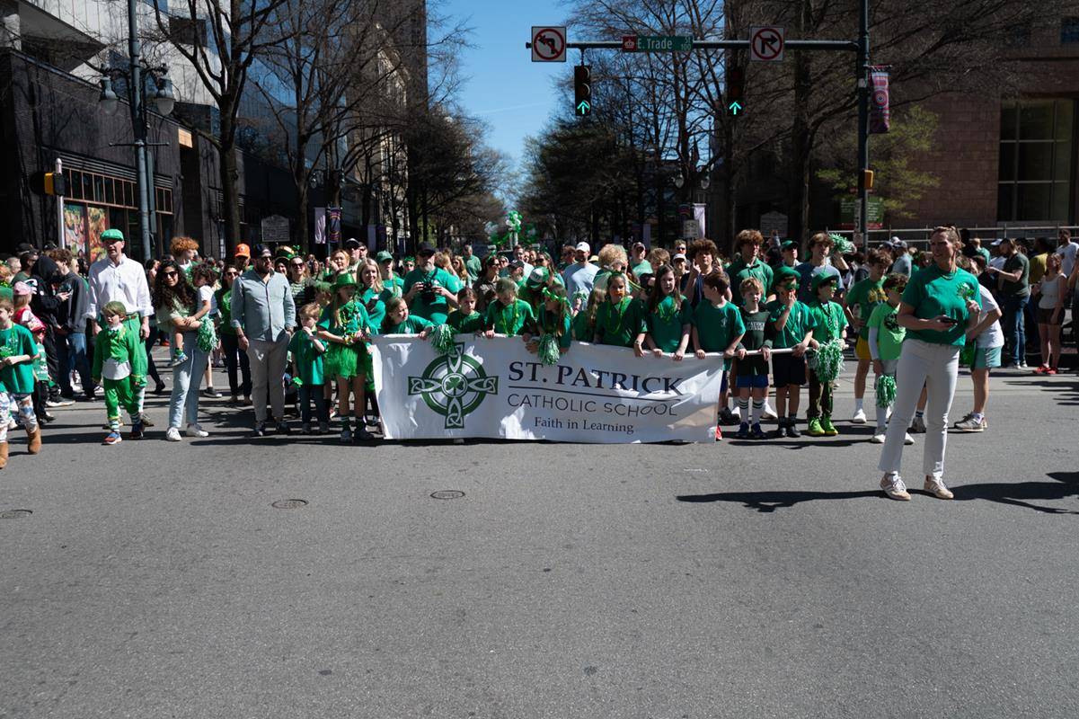 Students, staff and family of St. Patrick school march in the parade.
