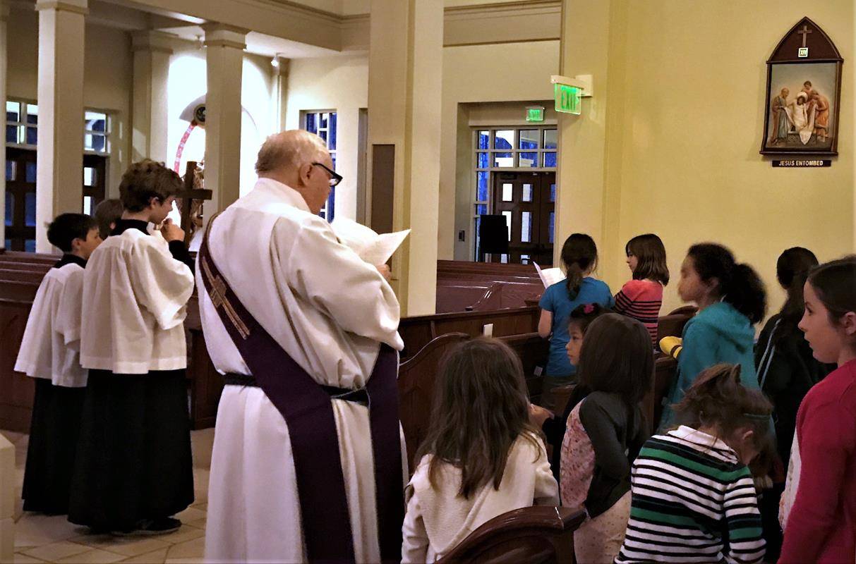HUNTERSVILLE — Children at St. Mark Church pray the Stations of the Cross, led by Deacon Ron Sherwood. (Photo provided by Amy Burger)