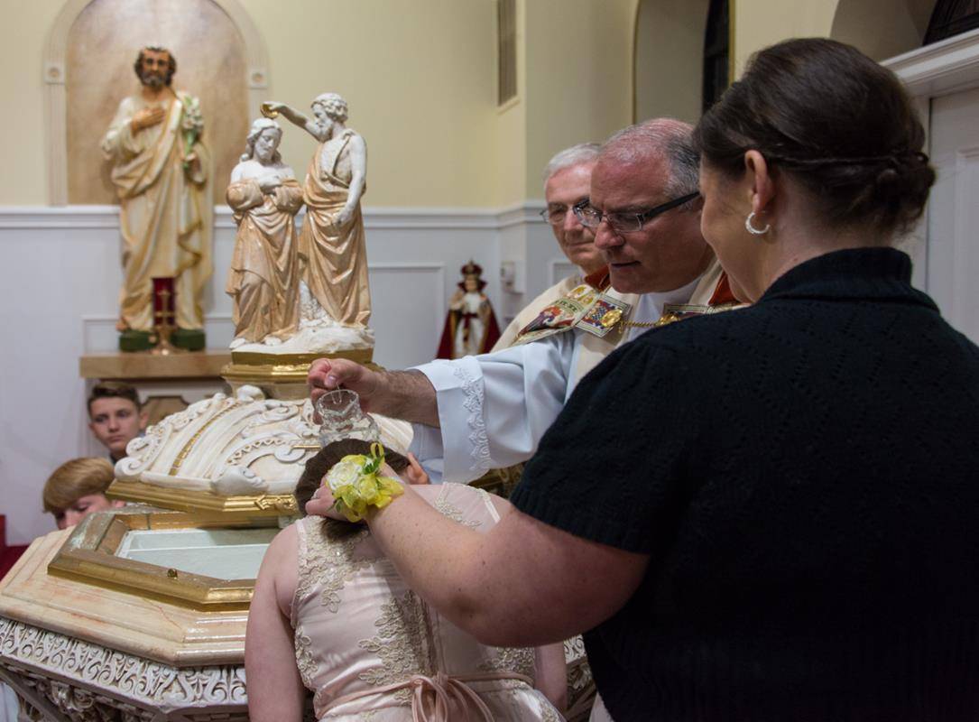 DENVER — Six adults and one child were received into the Church during Holy Spirit Church’s Easter Vigil. (By Doreen Sugierski)